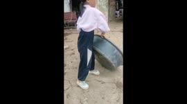 Young girl in China shows off martial arts skill balancing on basin edge