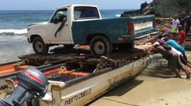Transporting a Pickup on Two Small Fishing Boats