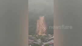 Landslide crashes into homes and cars amid heavy rain in Malaysia