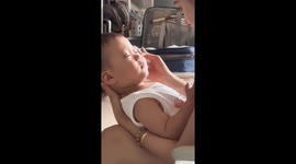 Doting auntie playfully applies fake eyelashes on child