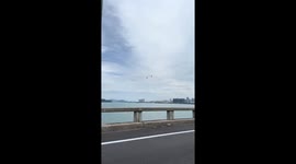 Workers install wires and cables on Penang Bridge