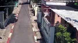 Tourist mugged by motorcycle-riding thief on quiet street in Bali