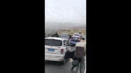 Yak carries two children through fields in China
