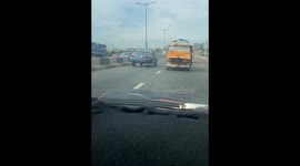 Car Precariously Driven On Three Wheels