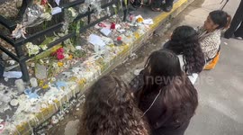 One Direction fans mourn at a vigil with tears, candles and songs at the hotel where he died