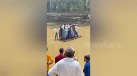 Locals cross river with makeshift raft to attend funeral