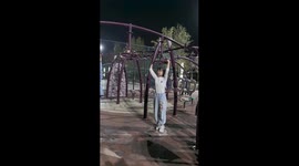 Girl spins rapidly on park equipment in Xinjiang