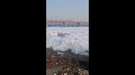 Thick layer of foam forms on river in India leaving locals baffled