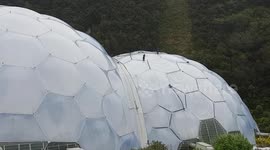 Eden Project work men with a couple of Mastic guns sealing around the edge of the double glazing .