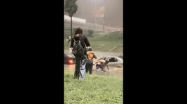 People escape car as floodwaters rise in Monterrey