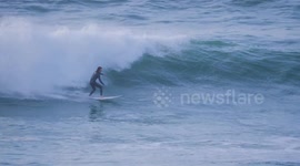 UK Weather, Storm Ashley hits Western Britain. Storm Surfer in the Bay, Fistral Bay, Newquay, Cornwall, UK