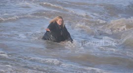 UK Weather, Storm Ashley hits Western Britain. Storm Woman caught on the beach by big waves, Fistral Bay, Newquay, Cornwall, UK