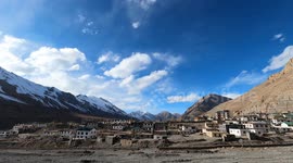 Time lapse of village in a valley Blue Sky Moving Clouds
