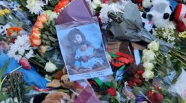 People lay floral tributes outside Downing Street for the 14,000 children killed in Gaza