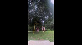 Two large girls topple garden swing