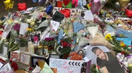 Fans leave flowers and tributes at a memorial for One Direction singer Liam Payne in Hyde Park, London