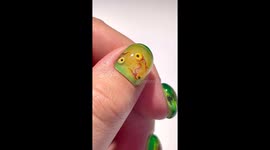 Hand painted nails that look like orbs with wet specimens inside