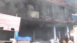 Fire destroys supermarket and row of shops in India