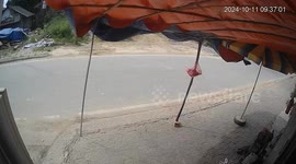 Motorcycle rider takes a tumble while avoiding wheel barrow user