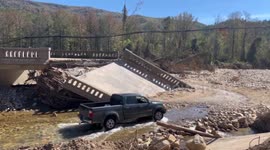 US: In Wake of Hurricane Helene, Truck Navigates Riverbed in Marion, Symbolizing Defiance