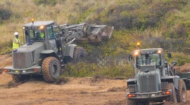British Army earth movers on a threatened habitat, for a good reason. Penhale Sands, Perranporth, Cornwall, UK