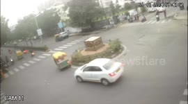 Biker injured after car out of control slams into roundabout in western India