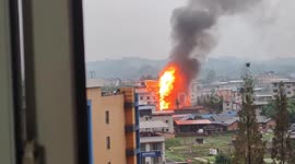 Explosive ball of flames shoots into the sky as building catches fire