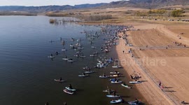 Hundreds of paddleboarders don witch hats for annual event
