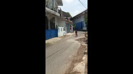 Playful mishap sends bicycle into ditch in Tasikmalaya, Indonesia