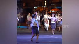 Locals perform traditional Thai dance on streets for festival