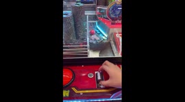 Arcade player has epic win on coin pusher game