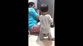 Toddler steals durian fruit from his grandmother