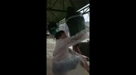 Residents climb bridge railings to escape floods in Cabagñan, Philippines