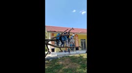 Students have fun on fallen tree in Gorontalo, Indonesia