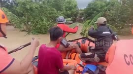 Philippine Coast Guard navigate flooded highway on rubber boat