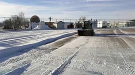 China: A Forklift Hauls Snow And Ice in Barkol