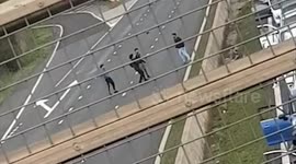 Pedestrians play football after M5 still shut due to 9.30am fire