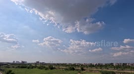 Time lapse of city highway fast moving traffic blue sky moving clouds