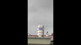 Monkey spotted riding rotating roof ventilator in Taiping, Malaysia