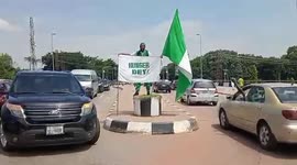 Flagman protest unbearable hunger on the street of Abuja, Nigeria
