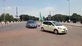 Flagman protest unbearable hunger on the street of Abuja, Nigeria