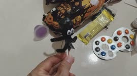 An adorable girl is frightened by a Halloween Toy