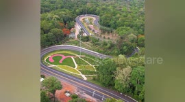 Aerial footage of Ping Ngu Curve that goes through lush forest in Thailand