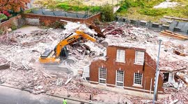 Shocking video shows massive digger crashing onto its side during demolition