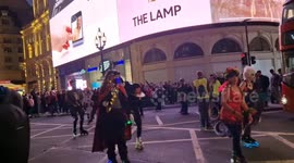 Halloween-themed skaters entertain as they pass through London's West End