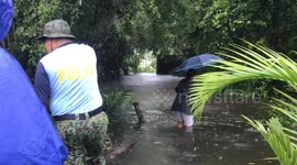 Rescue teams evacuate families from typhoon floods in the Philippines