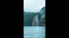 Stunning waterfall flows into the ocean