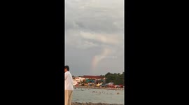 Rare 'rainbow tornado' forms over beach in the Philippines