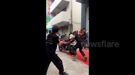 Reckless biker performing stunts loses control of motorcycle seeing it crash into parked cars