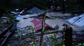 Roof-level floods from Tropical Storm Trami submerge homes